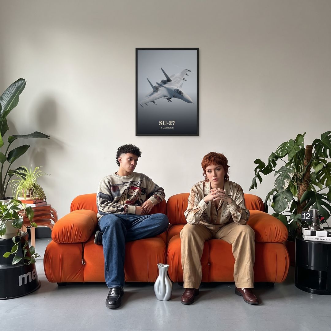 Su-27 Flanker, framed in black, in a retro orange sofa lounge
