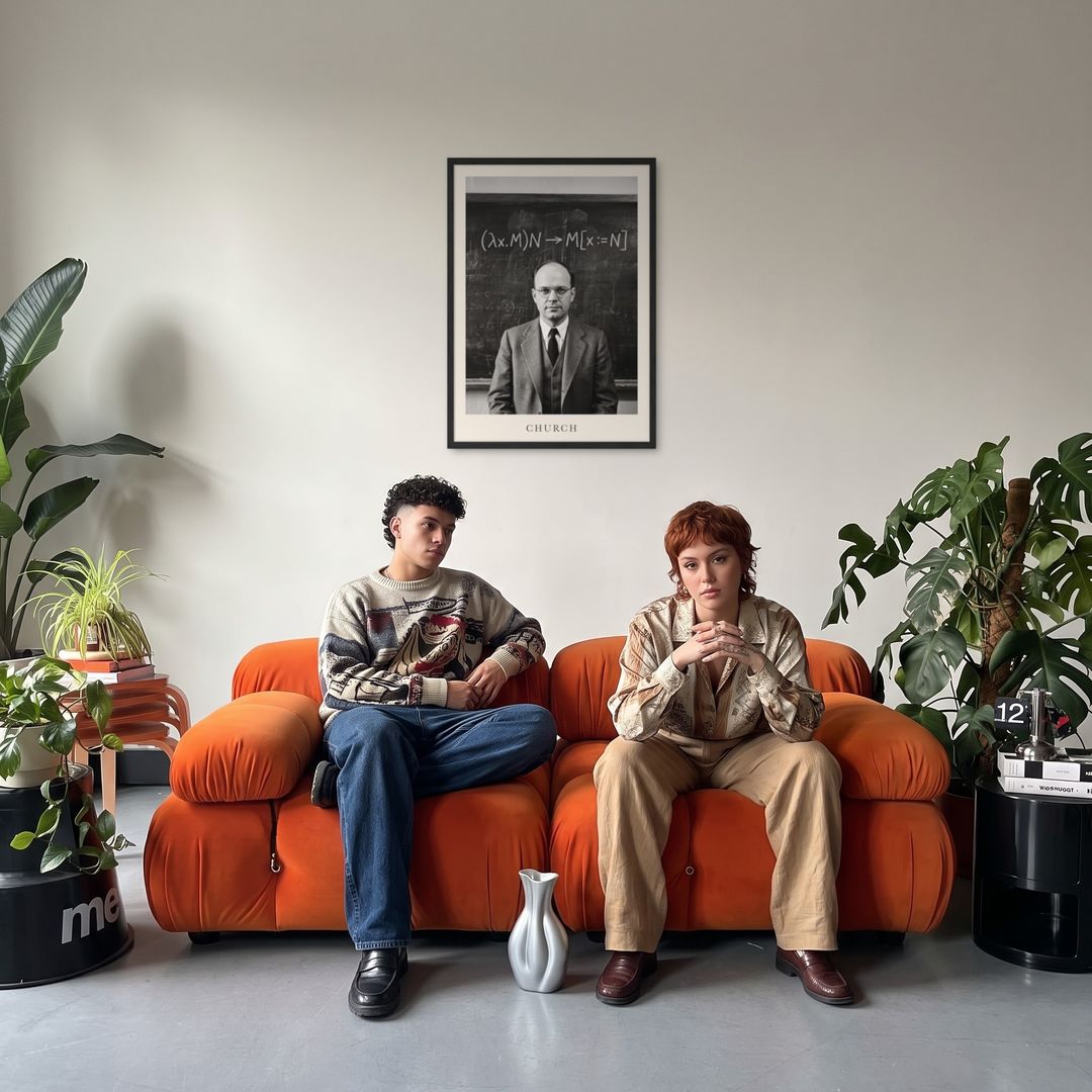 Alonzo Church, framed in black, in a retro orange sofa lounge