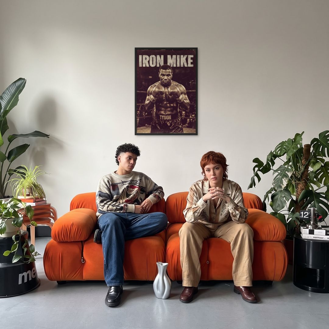 Iron Mike, framed in black, in a retro orange sofa lounge