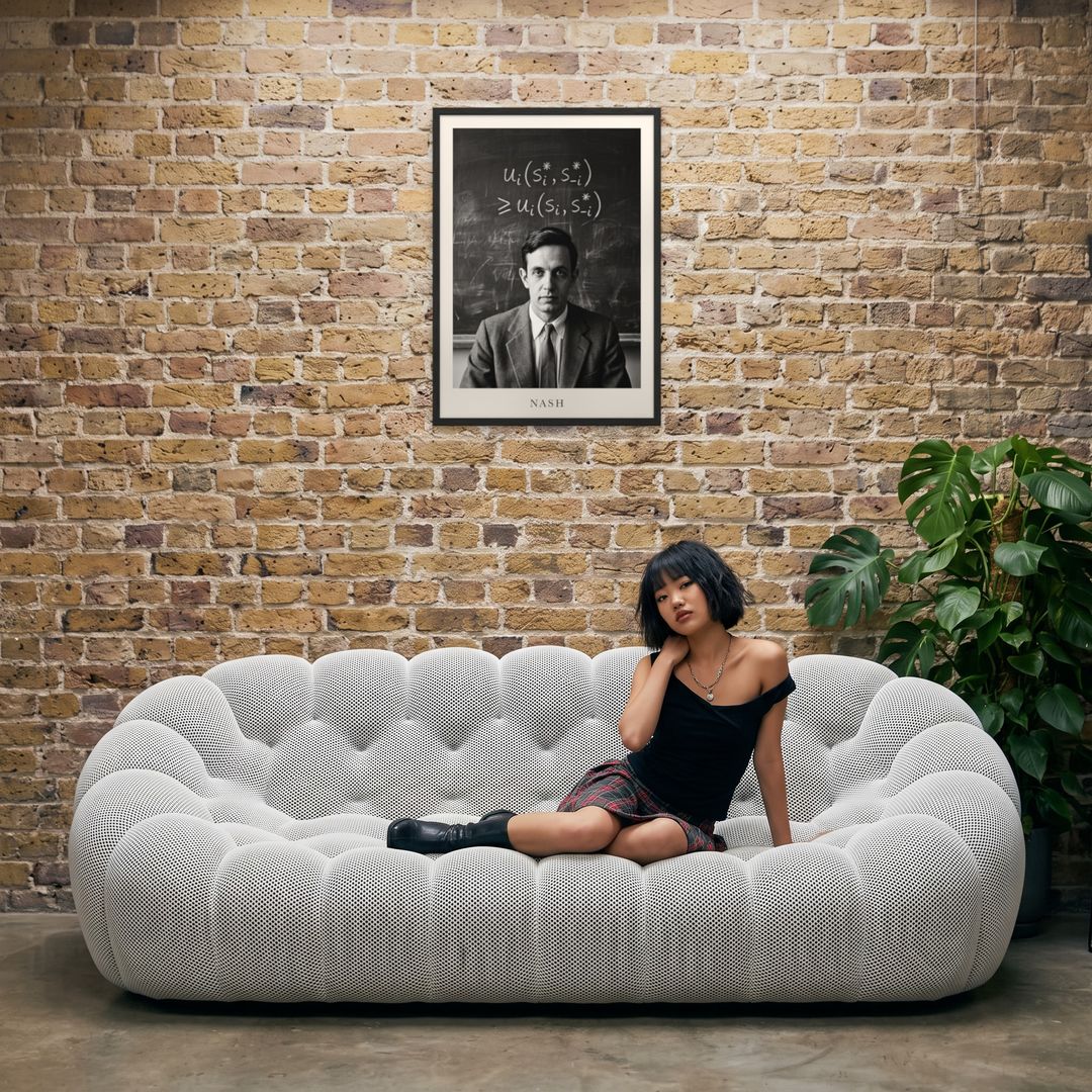 John Nash, framed in black, in an industrial loft with tufted sofa