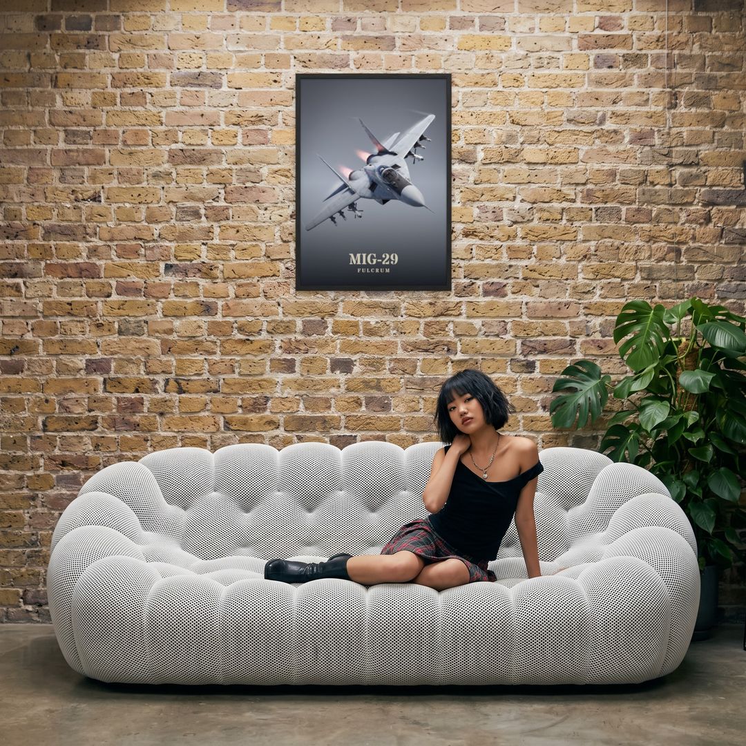MiG-29 Fulcrum, framed in black, in an industrial loft with tufted sofa