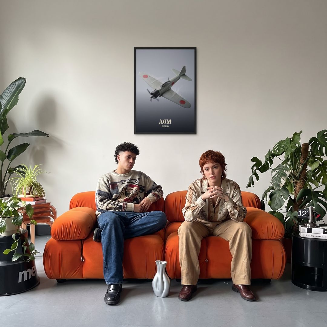 A6M Zero, framed in black, in a retro orange sofa lounge