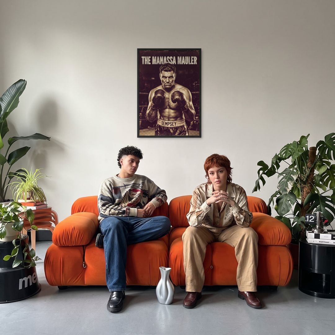 The Manassa Mauler, framed in black, in a retro orange sofa lounge