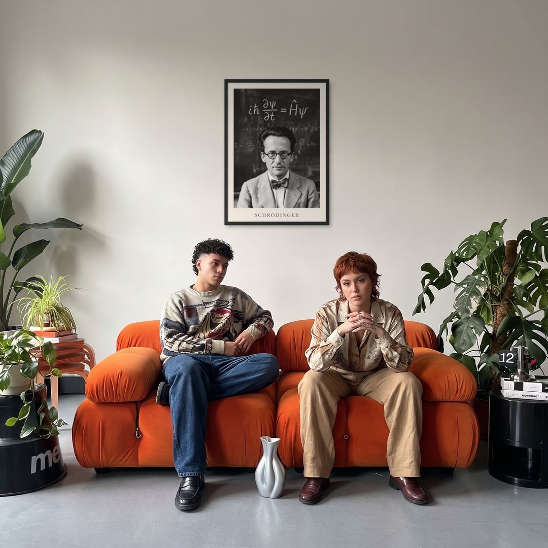 Erwin Schrödinger, framed in black, in a retro orange sofa lounge