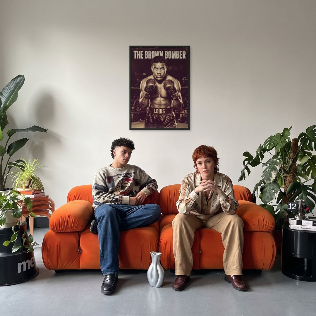 The Brown Bomber, framed in black, in a retro orange sofa lounge