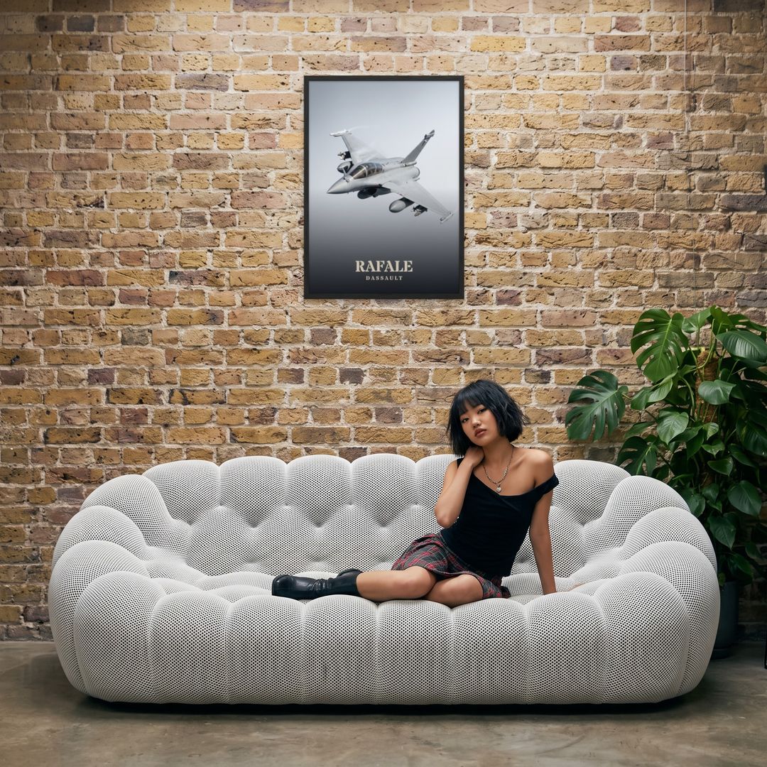 Rafale, framed in black, in an industrial loft with tufted sofa