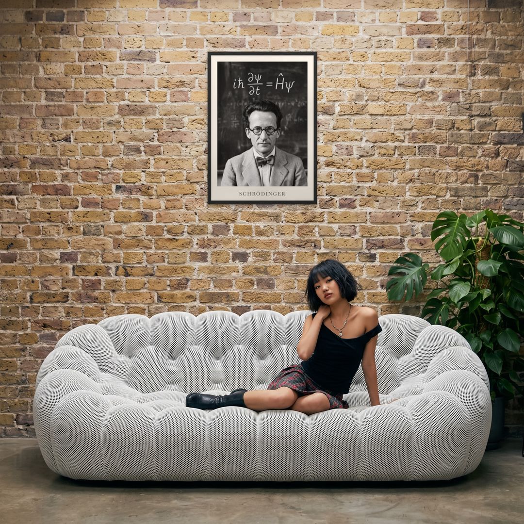 Erwin Schrödinger, framed in black, in an industrial loft with tufted sofa