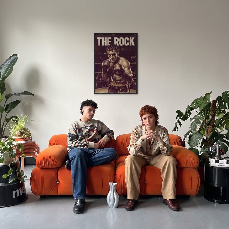 The Rock, framed in black, in a retro orange sofa lounge